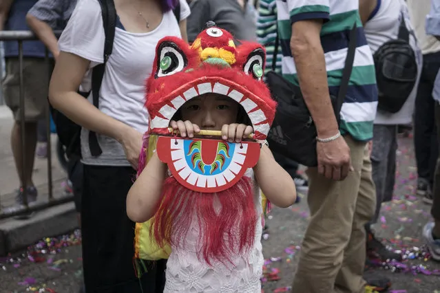 A child wearing his dragon costume during the Buddha's Birthday festival in Shau Kei Wan, Hong Kong, on May 3, 2017. Buddha's Birthday is a festival traditionally celebrated the Buddhism. People dressed up with traditional costumes and danced with the dragon. (Photo by Chan Long Hei/Pacific Press/LightRocket via Getty Images)
