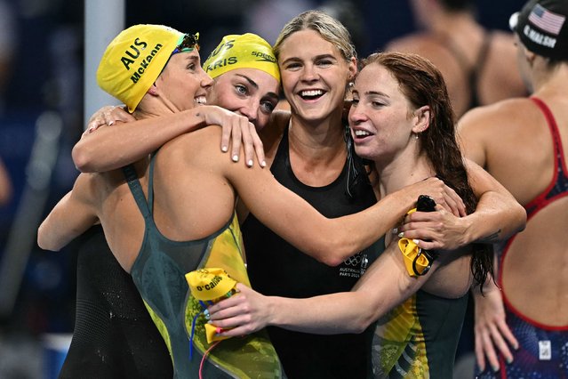 Australia's Emma McKeon, Meg Harris, Shayna Jack and Mollie O'Callaghan celebrate after winning the women's 4x100-meter freestyle relay on July 27, 2024. The team set an Olympic record with a time of 3:28:92. (Photo by Manan Vatsyayana/AFP Photo)