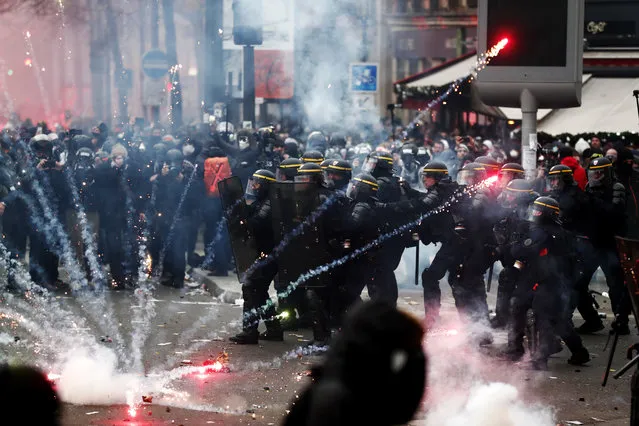 French riot police clash with protesters during a demonstration against pension reforms Paris, France, 05 December 2019. Unions representing railway and transport workers and many others in the public sector have called for a general strike and demonstration to protest against French government's reform of the pension system. (Photo by Ian Langsdon/EPA/EFE)