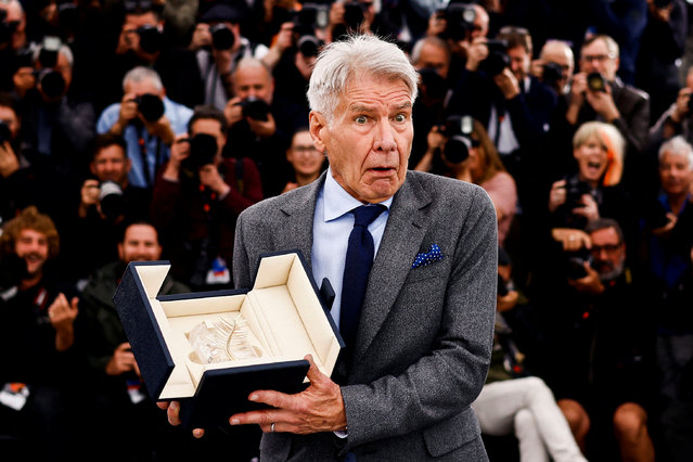 American actor Harrison Ford poses with his Honorary Palme d'Or for the film Indiana Jones and the Dial of Destiny during the 76th edition of the Cannes Film Festival at Palais des Festivals in Cannes, France on May 19, 2023. (Photo by Yara Nardi/Reuters)