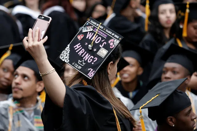 A graduating student of the City College of New York takes a selfie of the message on her cap during the College's commencement ceremony in the Harlem section of Manhattan, New York, U.S., June 3, 2016. (Photo by Mike Segar/Reuters)