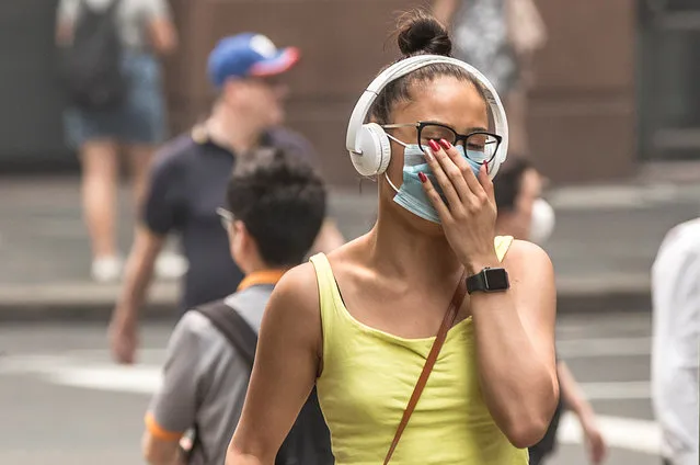A woman walks through Martin Place in Sydney , Australia on December 9, 2019, wearing a face masks to try and limit the effects of the smoke. (Photo by Jessica Hromas/The Guardian)