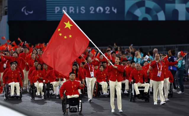 Flagbearers Haiyan Gu of China and Yongkai Qi of China lead their contingent during the Paris 2024 Paralympic Games Opening Ceremony in Paris on August 28, 2024. (Photo by Gonzalo Fuentes/Reuters)