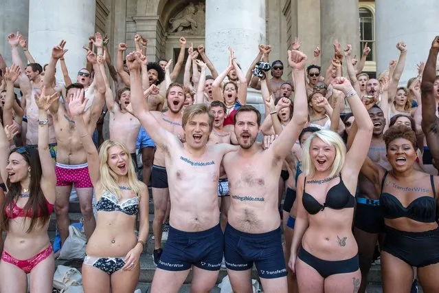 A flashing flashmob paraded around central London in their underwear in a protest over bank charges, on June 13, 2014. The semi-naked gang stripped down to their bras and briefs – giving morning commuters an eyeful. The scantily clad protesters stunned passengers at Liverpool Street Station and were also spotted in Angel, Farringdon and Kings Cross Square. More than 100 daring campaigners turned out for the event – which luckily coincided with the warmest day of the year so far. (Photo by Jeff Moore)