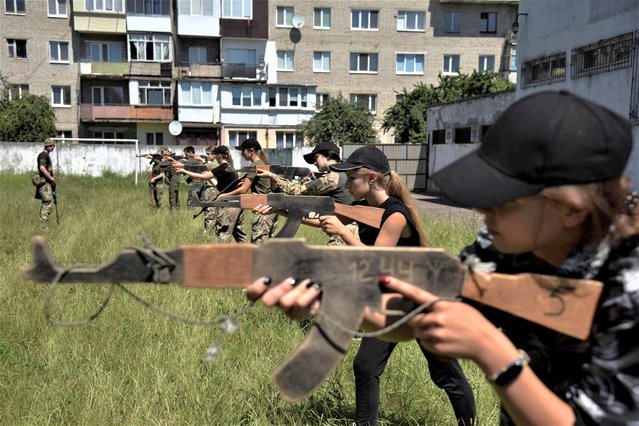 Teenagers attend a military training conducted by members of the Ukrainian Volunteer Corps, amid Russia's attack of Ukraine, in Lviv region, Ukraine on July 16, 2023. (Photo by Pavlo Palamarchuk/Reuters)