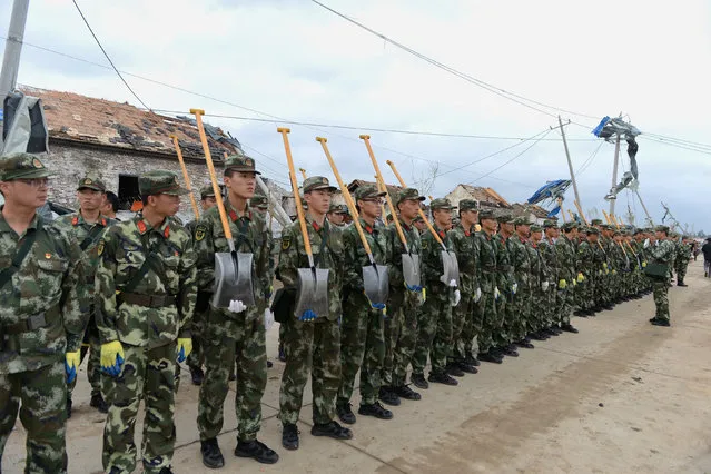 Paramilitary policemen carry shovels as they prepare for rescue work after a tornado hit Funing on Thursday, in Yancheng, Jiangsu province, June 24, 2016. (Photo by Reuters/Stringer)