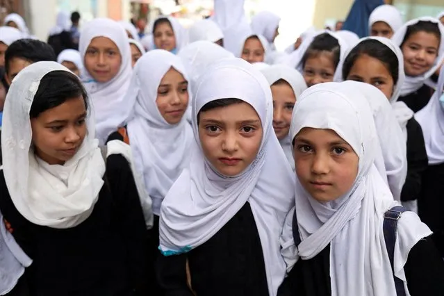 Afghan girls are seen on a street in Kabul, Afghanistan, May 10, 2022. (Photo by Ali Khara/Reuters)