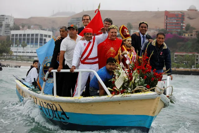 Peruvians commemorate the Day of the Fisherman by taking a statue of Saint Peter out on a boat along the coast in Lima June 29, 2016. (Photo by Guadalupe Pardo/Reuters)