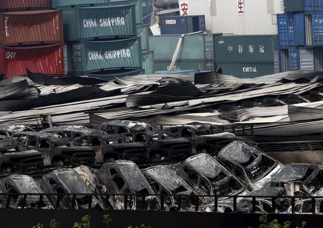 Burnt vehicles and damaged containers are seen near the site of last week's explosions at Binhai new district in Tianjin, China, August 17, 2015. (Photo by Kim Kyung-Hoon/Reuters)