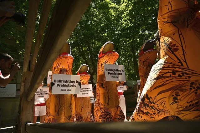 People dressing as dinosaurs protest against animal cruelty before the start of the San Fermin festival, which has been cancelled for the last two years due to coronavirus restrictions, in Pamplona, northern Spain, Tuesday, July 5, 2022. People from around the world flock to Pamplona to take part in the nine days of the festival which starts on Wednesday, July 6Alvaro Barrientos