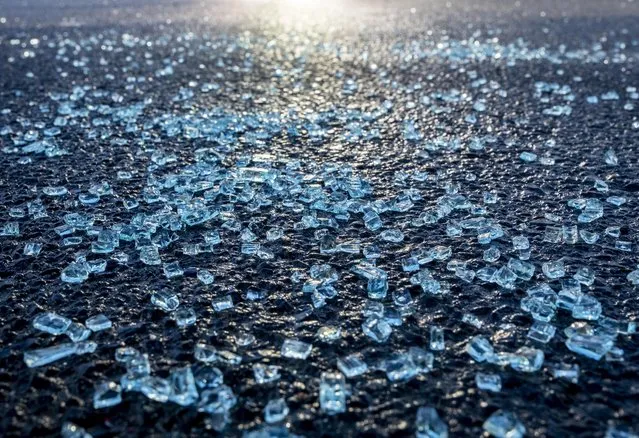 Broken glass from the window of a car in which a man was shot lies on the street in front of a kiosk in Hanau, Germany Friday, February 21, 2020 two days after a 43-year-old German man shot and killed several people at several locations in a Frankfurt suburb on Wednesday, Feb. 19, 2020. (Photo by Michael Probst/AP Photo)
