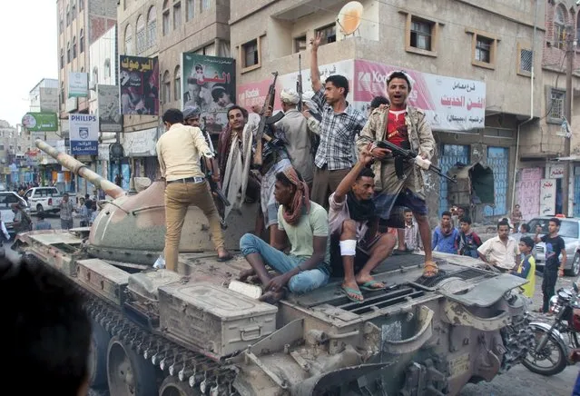 Militants loyal to Yemen's exiled government ride atop a tank they seized from Houthi militiamen in the country's central city of Taiz August 17, 2015. (Photo by Reuters/Stringer)