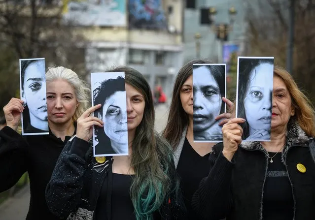 Activists of the “Declic” movement for women's rights hold printed half face pictures showing victims of domestic violence during a protest in Bucharest on March 4, 2020, to draw attention to the lack of monitoring bracelets on the aggressors once a restraining order was issued. On Thursday, March 5, the draft law on electronic monitoring of the offenders should receive the advice of the Legislative Council of Parliament. Over 14,000 members of the “Declic” community, a civil society NGO, call on parliamentarians to speed up the adoption of the draft law for electronic monitoring of the agressors. In Romania, 30% of women say they have been affected by physical or sexual violence at some point in their lives. In 2018, nearly 18,000 women were hit by family members. The rate of women killed in Romania is above the average registered in the EU member states. (Photo by Daniel Mihailescu/AFP Photo)