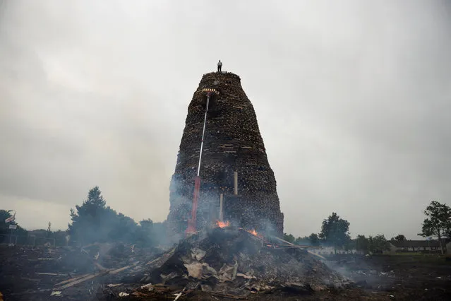 A bonfire is seen in Ballymacash, which will be set alight at midnight on Monday, ahead of the Twelfth of July celebrations held by members of the Orange Order in Lisburn, Northern Ireland, July 10, 2016. (Photo by Clodagh Kilcoyne/Reuters)
