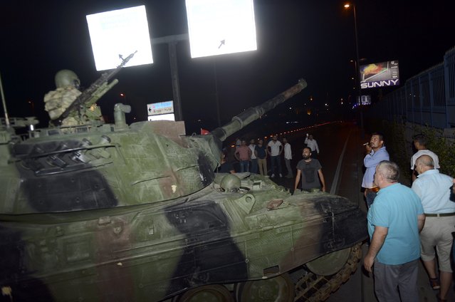 A crowd forms in front of a Turkish armoured vehicle at Ataturk airport in Istanbul, Turkey July 16, 2016. (Photo by Reuters/IHLAS News Agency)