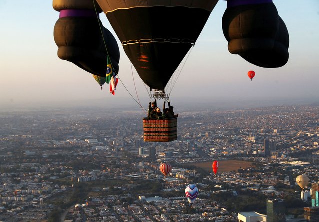 Hot-air balloons fly over Metropolitano park during the International Hot-Air Balloon Festival in Leon, state of Guanajuato, Mexico, on November 16, 2024. (Photo by Henry Romero/Reuters)