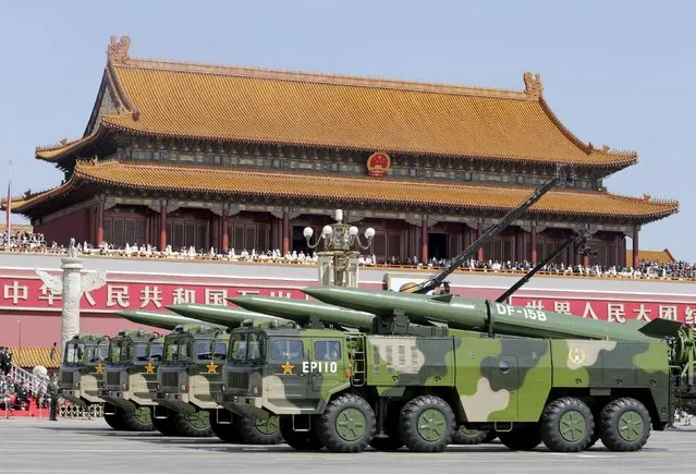 Military vehicles carrying DF-15B short-range ballistic missiles drive past the Tiananmen Gate during a military parade to mark the 70th anniversary of the end of World War Two, in Beijing, China, September 3, 2015. (Photo by Jason Lee/Reuters)