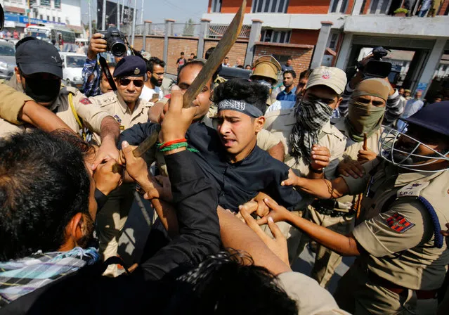 Indian policemen try to snatch a sword from a Kashmiri Shiite Muslim as they detain him during a Muharram procession in Srinagar, the summer capital of Indian Kashmir, 29 September 2017. Dozens of Shiite mourners were detained by Indian Police after they tried to bring out a Muharram procession through the city center. Authorities had imposed restrictions in parts of Srinagar to prevent Shiite mourners from taking out mourning processions on the 8th day of Muslim holy month of Muharram. Authorities have banned main Muharram procession in city center after the eruption of militancy in the region in 1989. However, Kashmiri Shiite Muslims except for the city center, have been bringing out Muharram procession throughout the region. (Photo by  Farooq Khan/EPA/EFE)