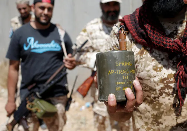 A fighter of Libyan forces allied with the U.N.-backed government shows a disarmed antipersonnel mine planted by Islamic State fighters in Sirte, Libya, July 31, 2016. (Photo by Goran Tomasevic/Reuters)