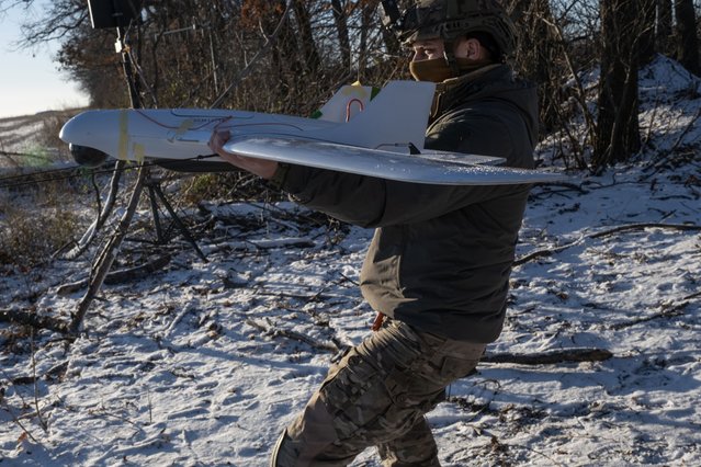 A Ukrainian serviceman of the 12th Special Operations Brigade “Azov” prepares to launch a Ukrainian 'Furia' unmanned aerial system (UAS) to conduct aerial reconnaissance mission at an undisclosed location near the frontline city of Toretsk, Donetsk region, eastern Ukraine, 14 December 2024, amid the Russian invasion. (Photo by Maria Senovilla/EPA/EFE)