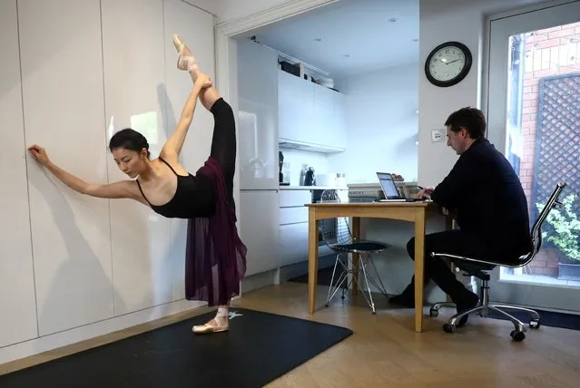 Yuhui Choe, First Soloist of The Royal Ballet practices as her husband, former Principal of the Royal Ballet, Nehemiah Kish works at their home in Wimbledon, following the coronavirus disease (COVID-19) outbreak in London, Britain, May 1, 2020. (Photo by Hannah McKay/Reuters)
