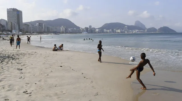 Kids play soccer on Copacabana beach on August 2, 2016 in Rio De Janeiro, Brazil. (Photo by Jonathan Newton/The Washington Post)