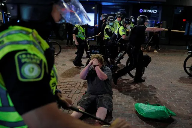 Police move past a protester they took down with batons following a rally against the death in Minneapolis police custody of George Floyd in Boston, Massachusetts, U.S., May 31, 2020. (Photo by Brian Snyder/Reuters)