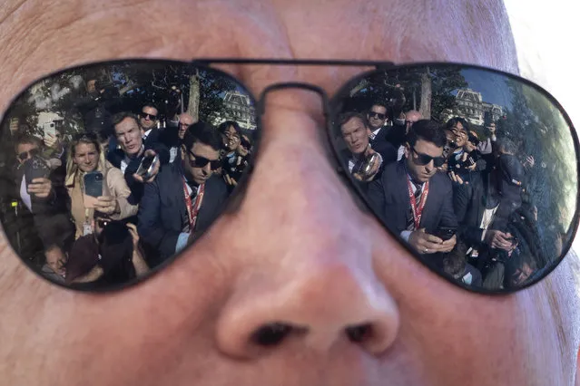 Reporters are reflected in the sunglasses of U.S. President Joe Biden as he speaks to the press before boarding Marine One on the South Lawn of the White House October 6, 2022 in Washington, DC. President Biden is traveling to Poughkeepsie, New York to tour an IBM facility. The company has invested $20 billion in the Hudson Valley region over the next 10 years, focused on semiconductors, computers, artificial intelligence and other programs. He will also stop in New York City and New Jersey for Democratic fundraising events. (Photo by Drew Angerer/Getty Images)