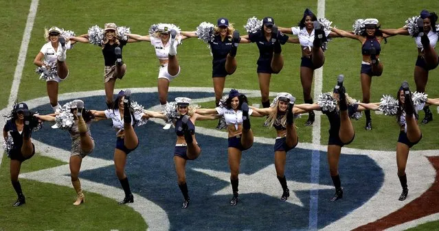 Texans cheerleaders, wearing outfits inspired by military uniforms, perform in Houston. (Photo by David J. Phillip/Associated Press)