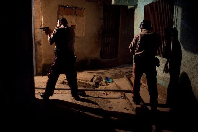 File photo of police patrolling the slum district of Petare in Caracas, Venezuela November 21, 2009. (Photo by Carlos Garcia Rawlins/Reuters)