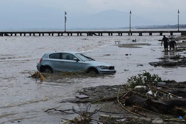 A car is abandoned in the sea in Agia Triada village about 20 kilometers from the city of Thessaloniki, northern Greece, after heavy overnight rain on Wednesday, September 7, 2016. Greek authorities said three people are dead and one is missing after the floods, which damaged homes and businesses in the southern Peloponnese region – where the deaths were recorded – and near Thessaloniki. (Photo by Giannis Papanikos/AP Photo)