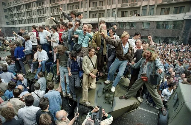 In this August 19, 1991 file photo, crowds of people surround and climb on tanks which were stopped by the crowd as they drove towards the Red Square area of Moscow, Russia, during a military coup after the announced ousting of Mikhail Gorbachev from power. In these critical days when Muscovites turned out to defend the spirit of democracy that Gorbachev had unleashed, and many Soviet officers defied their orders and sided with the people, ensuring that that the plotters failed. (Photo by Boris Yurchenko/AP Photo)