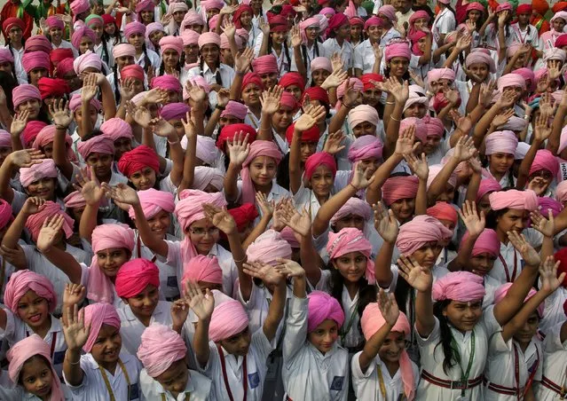 Girls wearing turbans wave as they take part in celebrations to mark the International Day of the Girl Child at a school premises in Chandigarh, India October 12, 2015. The International Day of the Girl Child is observed on October 11 every year. (Photo by Ajay Verma/Reuters)