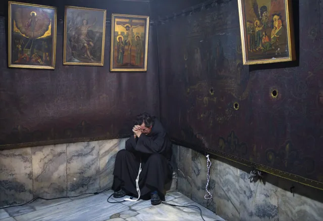 A Franciscan monk prays in the “Grotto” of the Church of Nativity, accepted by Christians as the birthplace of Jesus Christ, in the West Bank city of Bethlehem, 24 December 2017. Thousands of pilgrims flocked to Bethlehem to take part in Christmas celebrations. (Photo by Jim Hollander/EPA/EFE)