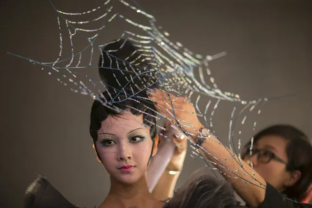 A model prepares backstage before Mao Geping-2016MGPIN Color Make-up Launch Show during the Mercedes-Benz China Fashion Week Spring/Summer 2016 at 751D.PARK Workshop on October 26, 2015 in Beijing, China. (Photo by Lintao Zhang/Getty Images)