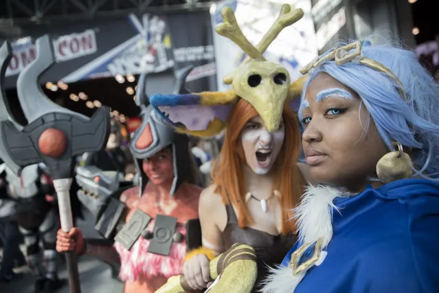 Brianna Oshrin, left, as Infernal Nasus, Brandy Babcock, center, as Gnar, and Athena Thomas as Freljord Taliyah pose for a photo during Comic Con, Friday, October 7, 2016, in New York. (Photo by Mary Altaffer/AP Photo)
