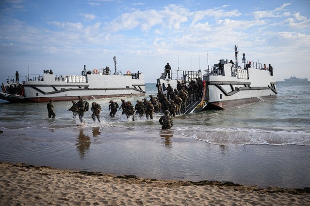 French troops disembark from a US landing craft during a joint US and French amphibious landing operation showcase, on June 4, 2024, at Omaha beach in Saint-Laurent-sur-Mer, northwestern France, ahead of the “D-Day” commemorations marking the 80th anniversary of the World War II Allied landings in Normandy. (Photo by Loic Venance/AFP Photo)