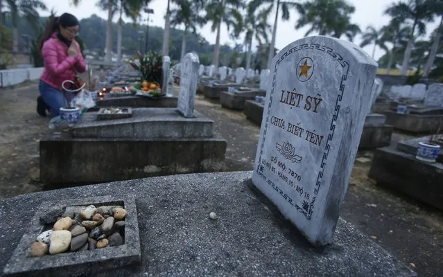 A tomb of an unknown soldier is pictured, on the 70th founding anniversary of the Vietnam People's Army, at the Viet-Laos cemetery in the border district of Anh Son December 22, 2014. The Viet-Laos cemetery has interred remains of nearly 11,000 remains of Vietnamese soldiers, most of them unidentified, who were killed during Vietnam War, according to cemetery officials. (Photo by Reuters/Kham)