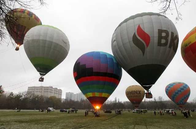 People fly on hot air balloons during a festival in Kyiv, Ukraine on 02 December 2020. The festival of hot air balloons “Montgolfieria”, which timed to the anniversary of the launch of the first balloon in history by the Montgolfier brothers, takes place in the Ukrainian capital. By purchasing the appropriate ticket, the festival visitors have the opportunity to make a short flight in a hot air balloon and take a picture. (Photo by NurPhoto via Getty Images)