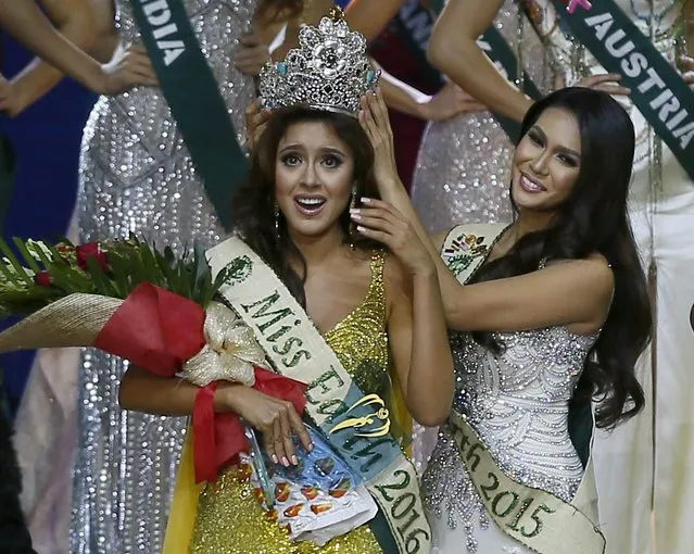 Katherine Espin, left, of Ecuador reacts shortly after being crowned Miss Earth 2016 by last year's winner Angelia Ong of the Philippines at the grand coronation night Saturday, October 29, 2016 at the Mall of Asia Arena in suburban Pasay city southeast of Manila, Philippines. Espin bested 83 other beauty candidates.(Photo by Bullit Marquez/AP Photo)