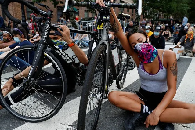 People hold a vigil near Gracie Mansion as protests against the death in Minneapolis police custody of George Floyd continue, in New York City, New York, U.S., June 3, 2020. (Photo by Andrew Kelly/Reuters)