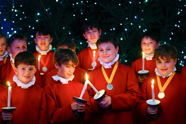 Choristers sing and hold candles during the lighting of the Christmas tree at Winchester Cathedral, on December 04, 2025 in Winchester, England. Winchester Cathedral�s Christmas tree lights are switched on during a short ceremony, as part of the annual blessing of the Christmas tree. The tree will remain on display throughout December where visitors can hear the choristers singing any a variety of services. (Photo by Finnbarr Webster/Getty Images)