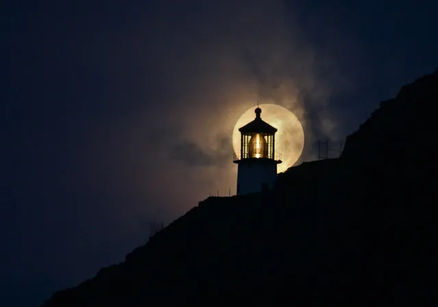 “Makapuu Moon”. Makapuu Lighthouse juxtaposed against a full moon. March 26, 2013. Location: Makapuu Beach, Oahu, Hawaii. (Photo and caption by Adam Lee/National Geographic Traveler Photo Contest)