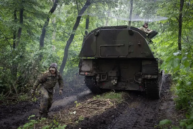 A Ukrainian army, German self-propelled Panzerhaubitze 2000, artillery drives to its position at the frontline near Bakhmut, Donetsk region, Ukraine, Saturday, May 27, 2023. (Photo by Efrem Lukatsky/AP Photo)