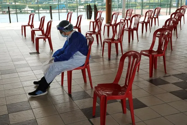 A medical worker rests at a coronavirus disease (COVID-19) testing centre in Petaling Jaya, Malaysia on January 25, 2021. (Photo by Lim Huey Teng/Reuters)