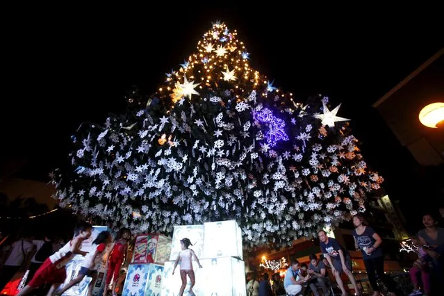 Residents gather in front of a Christmas tree at a mall in Manila, Philippines, December 4, 2015. (Photo by Janis Alano/Reuters)