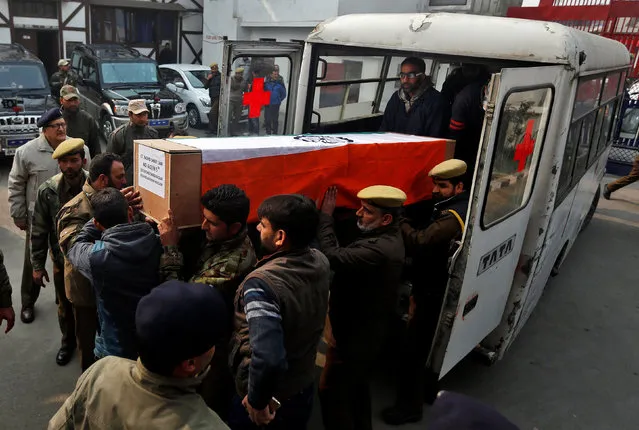 Indian police officers carry a coffin containing the body of their fallen colleague Mohammad Shafi Dar, who according to the police was killed in an encounter with suspected militants on Wednesday, during his wreath ceremony in Srinagar, November 16, 2016. (Photo by Danish Ismail/Reuters)