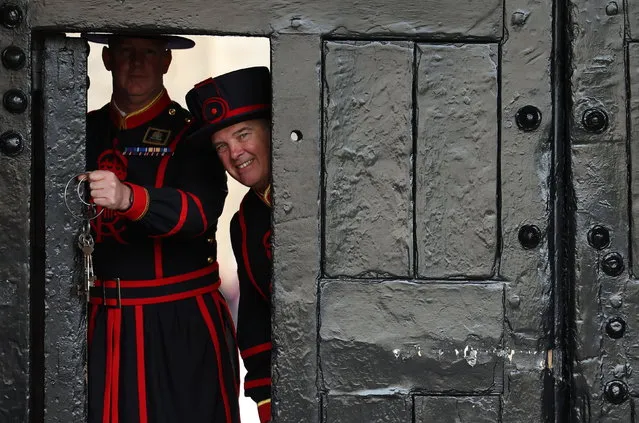 The new Chief Yeoman Warder Rob Fuller (L) and Yeoman Gaoler Clive Towell (R) pose at at the door during a photocall at the Tower of London in London, Britain, 18 July 2023. Yeomen Warders of His Majesty's Royal Palace and Fortress the Tower of London, and Members of the Sovereign's Body Guard of the Yeoman Guard Extraordinary are popularly known as the Beefeaters. They are ceremonial guardians of the Tower of London, that was constructed by William the Conqueror in 1078 and over the years has been used as a palace armory and prison. (Photo by Neil Hall/EPA)