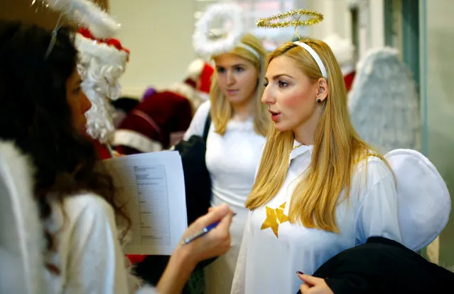 People dressed in Santa Claus and Christmas angels costumes attend an annual meeting of a university's rent-a-Santa Claus service in Berlin, Germany, November 26, 2016. (Photo by Hannibal Hanschke/Reuters)