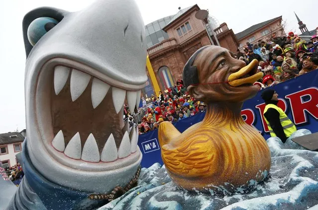 A carnival float with a papier-mache caricature of U.S. President Barack Obama, takes part in the traditional Rose Monday carnival parade in the western German city of Duesseldorf February 16, 2015. (Photo by Ralph Orlowski/Reuters)